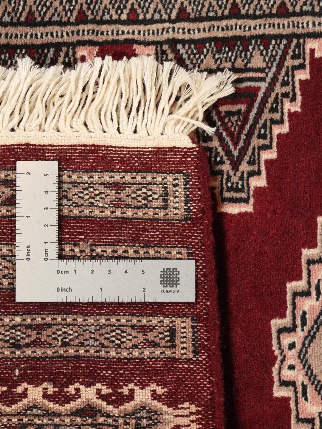 Hand-knotted Pakistan Bokhara rug in deep red with geometric medallions