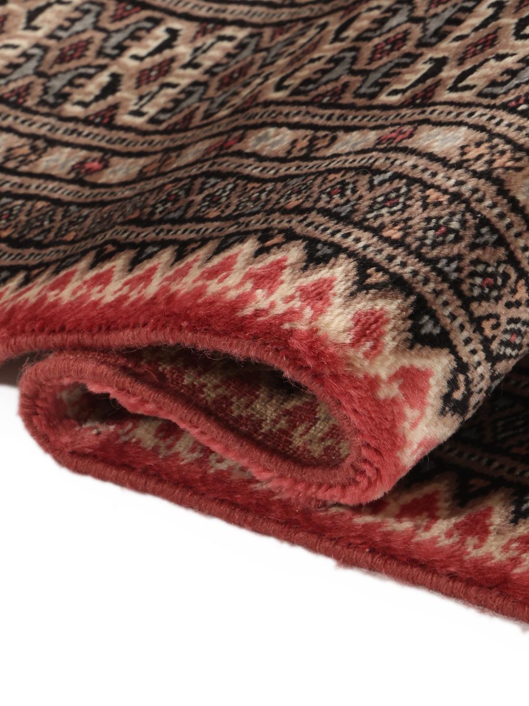 Hand-knotted red Pakistan Bokhara rug with geometric motifs