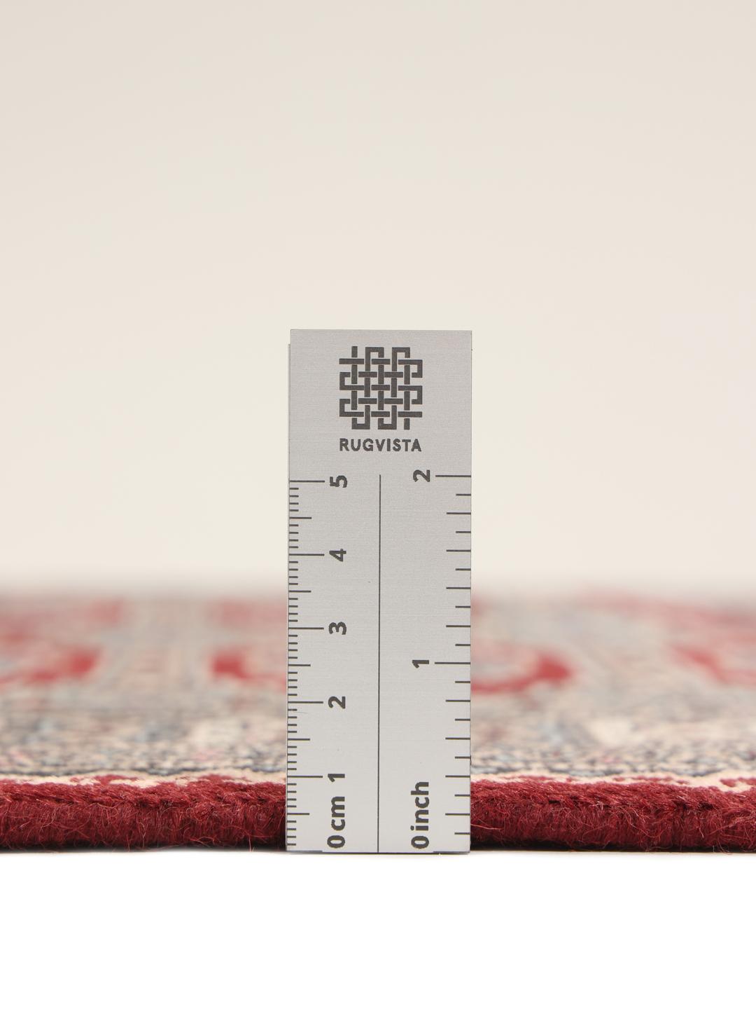 A hand-knotted Pakistan Bokhara rug with a dark-red field and classic geometric motifs.