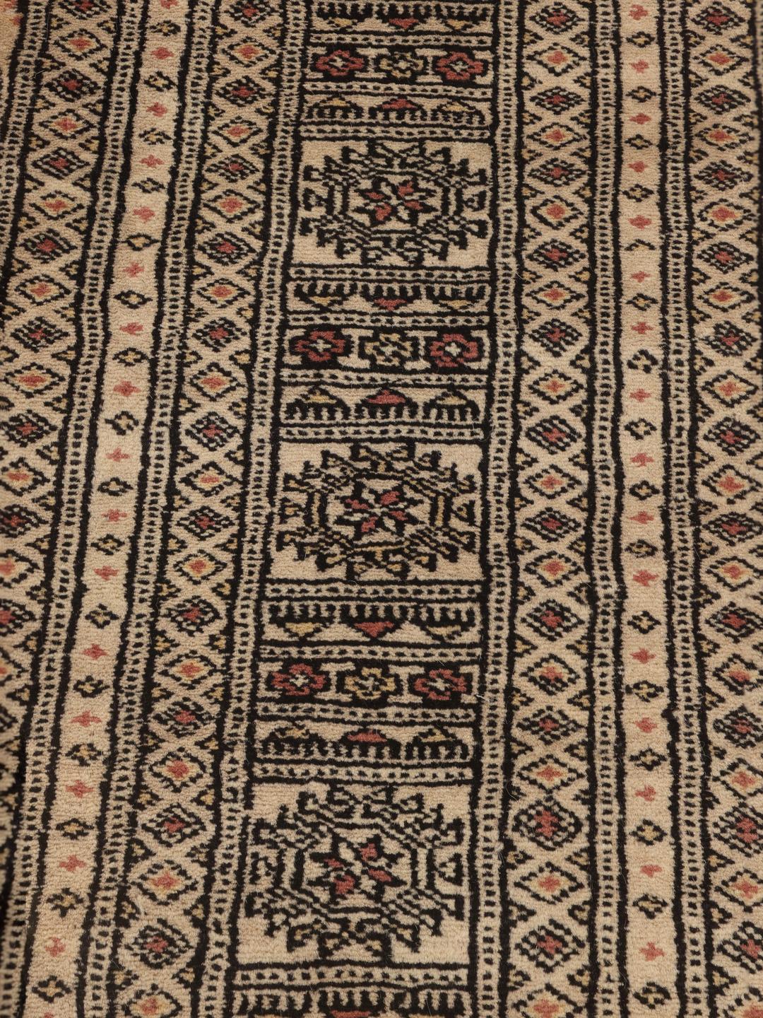 Hand-knotted Pakistan Bokhara rug with a beige field and traditional motifs