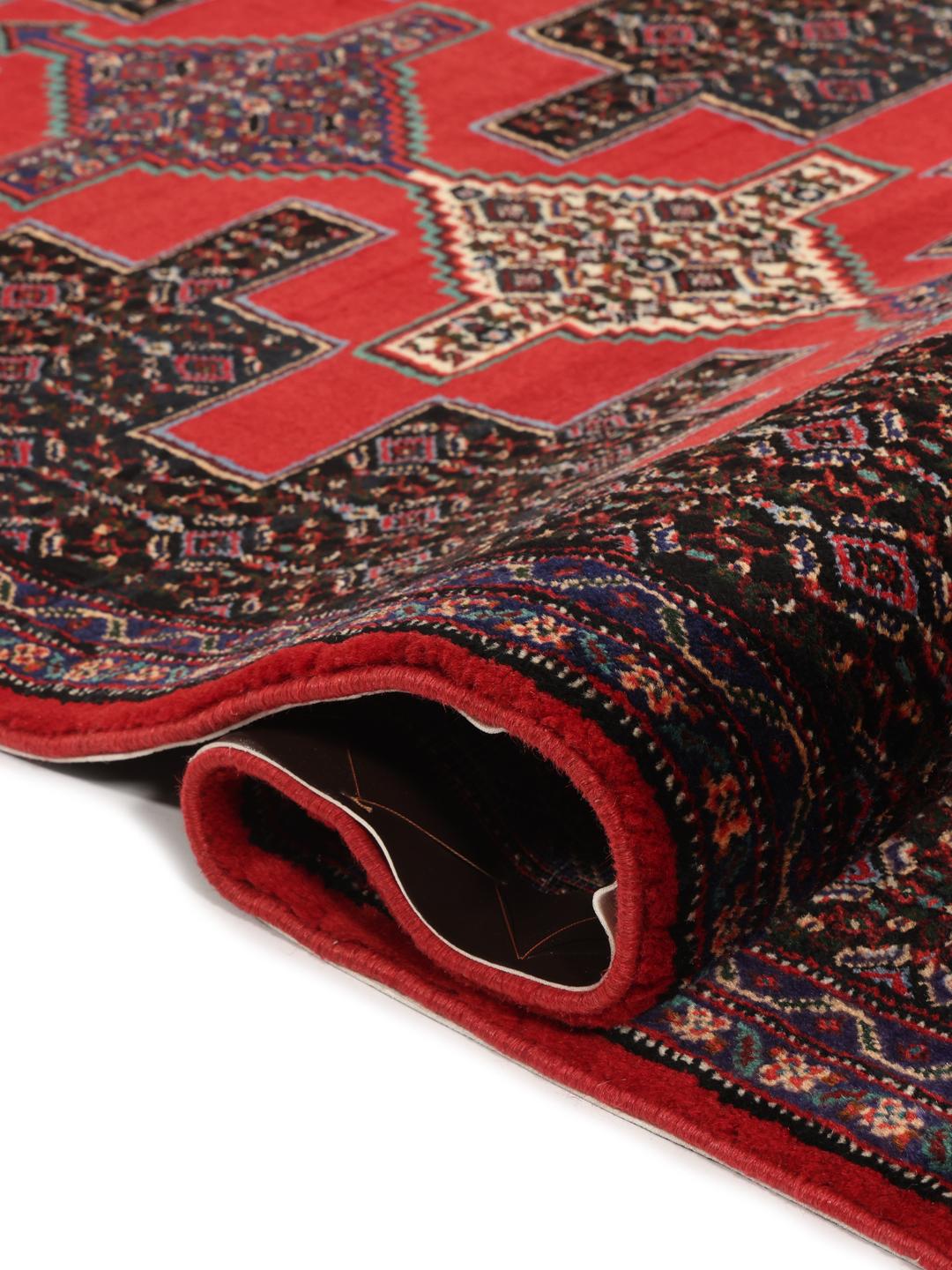 A hand-knotted Senneh runner from the Middle East in dark-red and black tones.