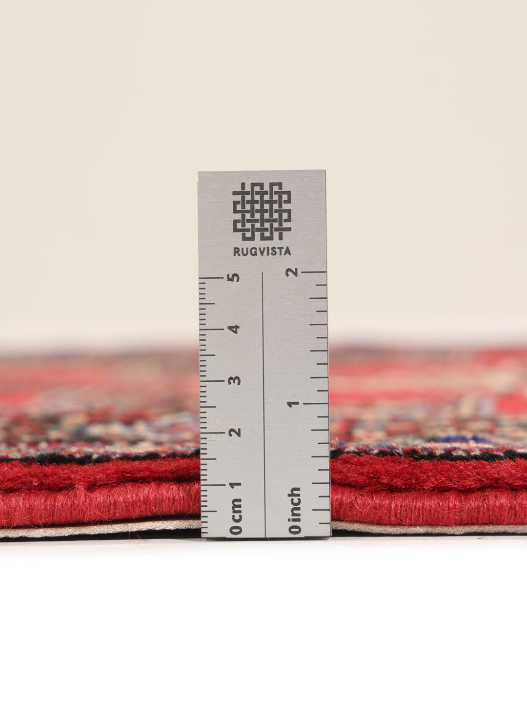 A hand-knotted Senneh runner from the Middle East in dark-red and black tones.