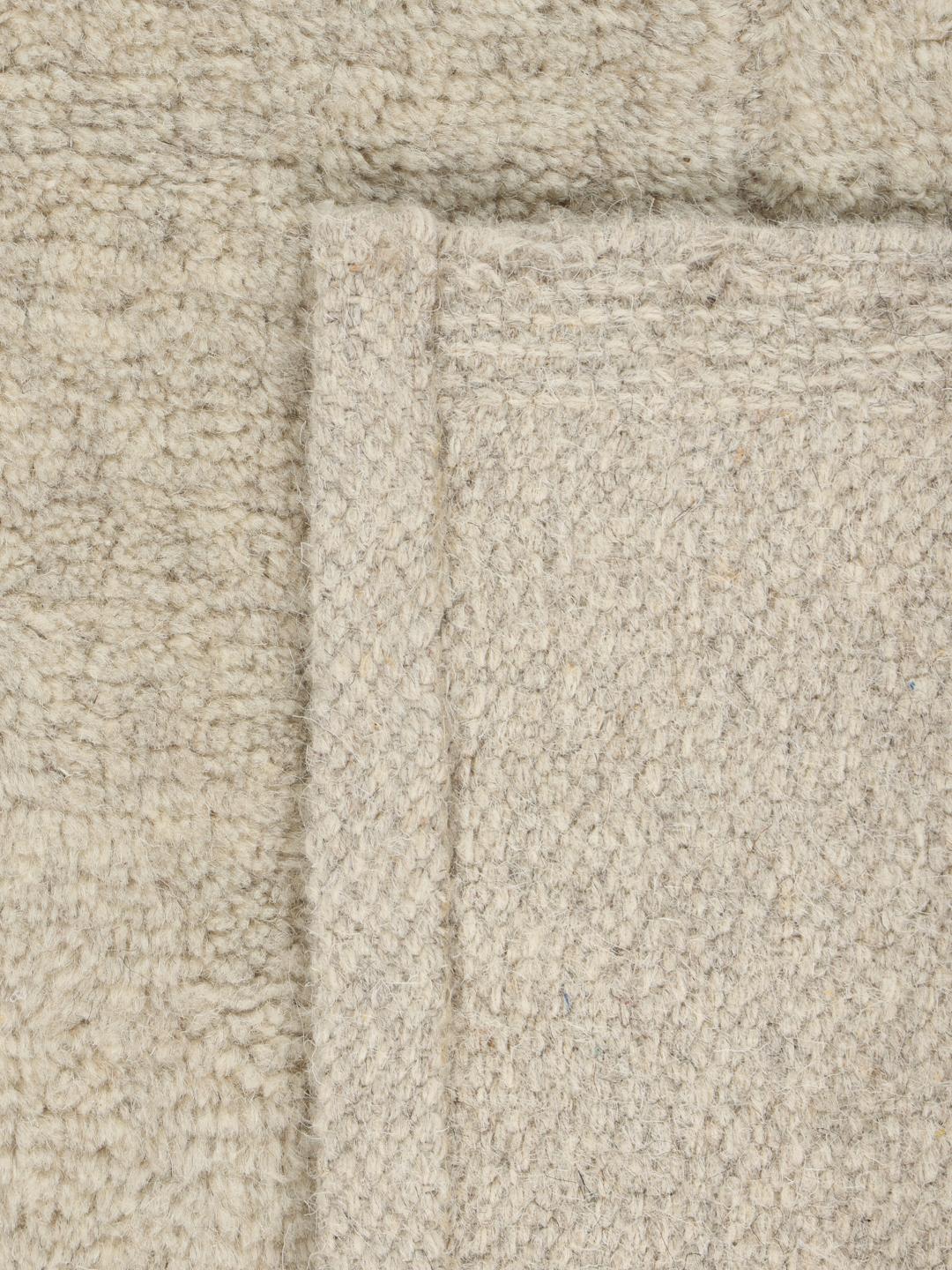 Beige tapijt met details in hoge en lage pool