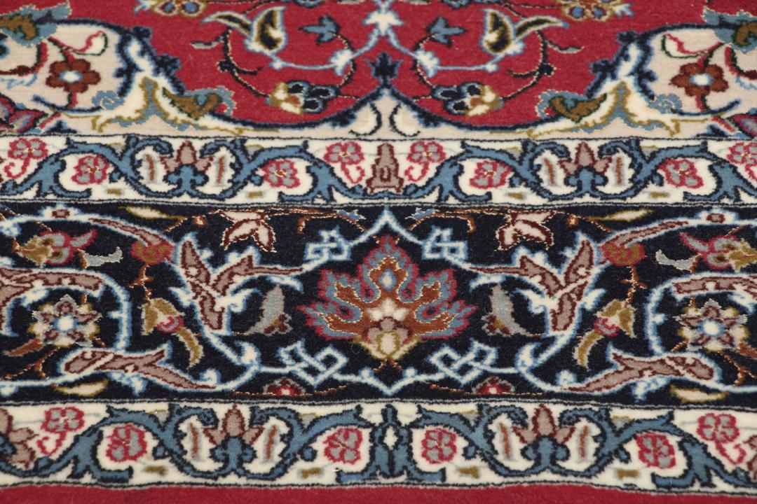 Hand-knotted Isfahan rug with dark-red and black floral patterns