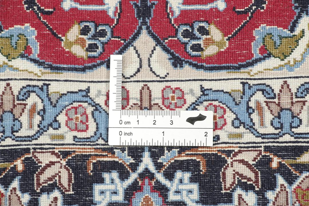 Hand-knotted Isfahan rug with dark-red and black floral patterns