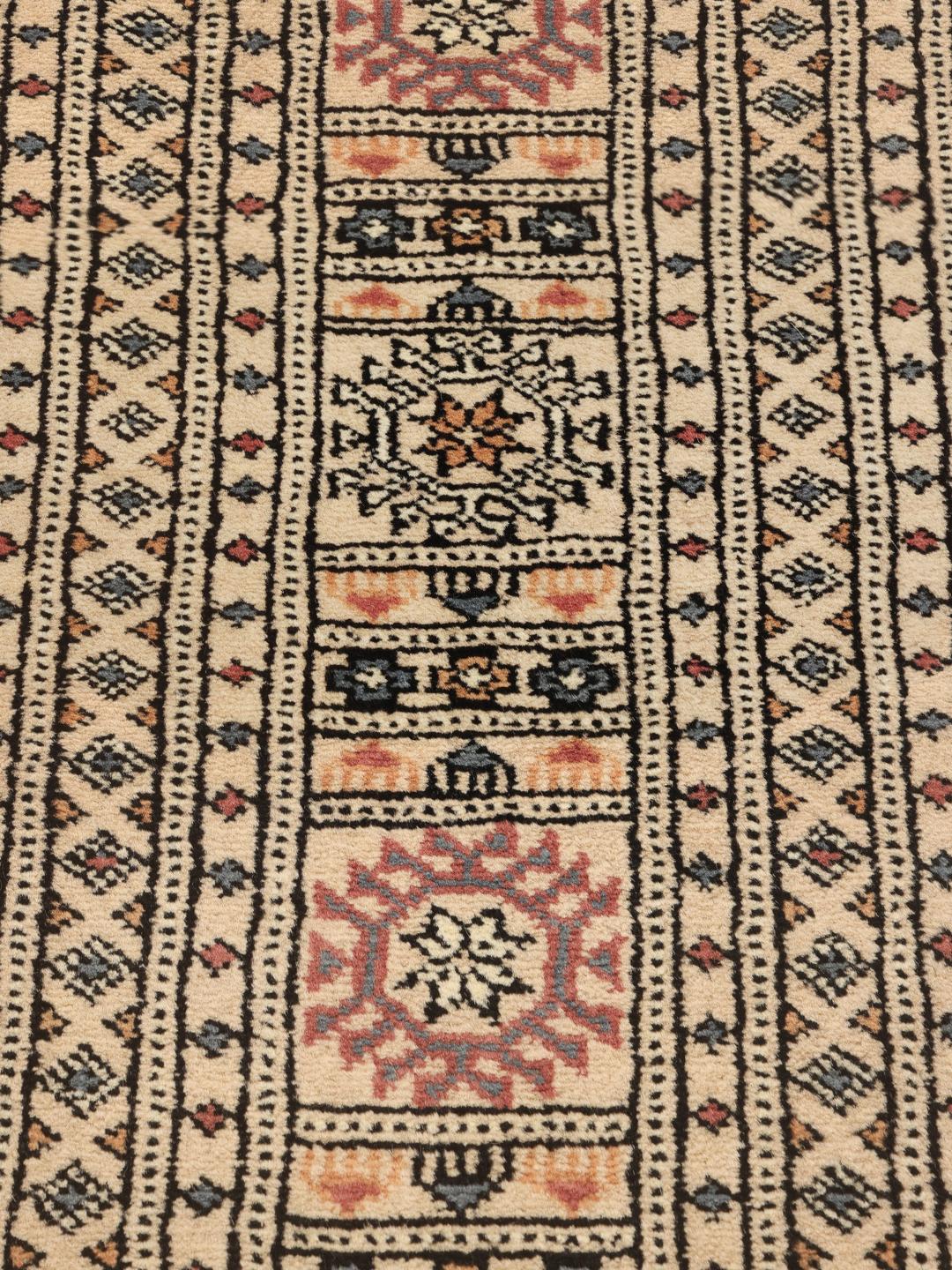 Hand-knotted Pakistan Bokhara rug with a beige wool pile