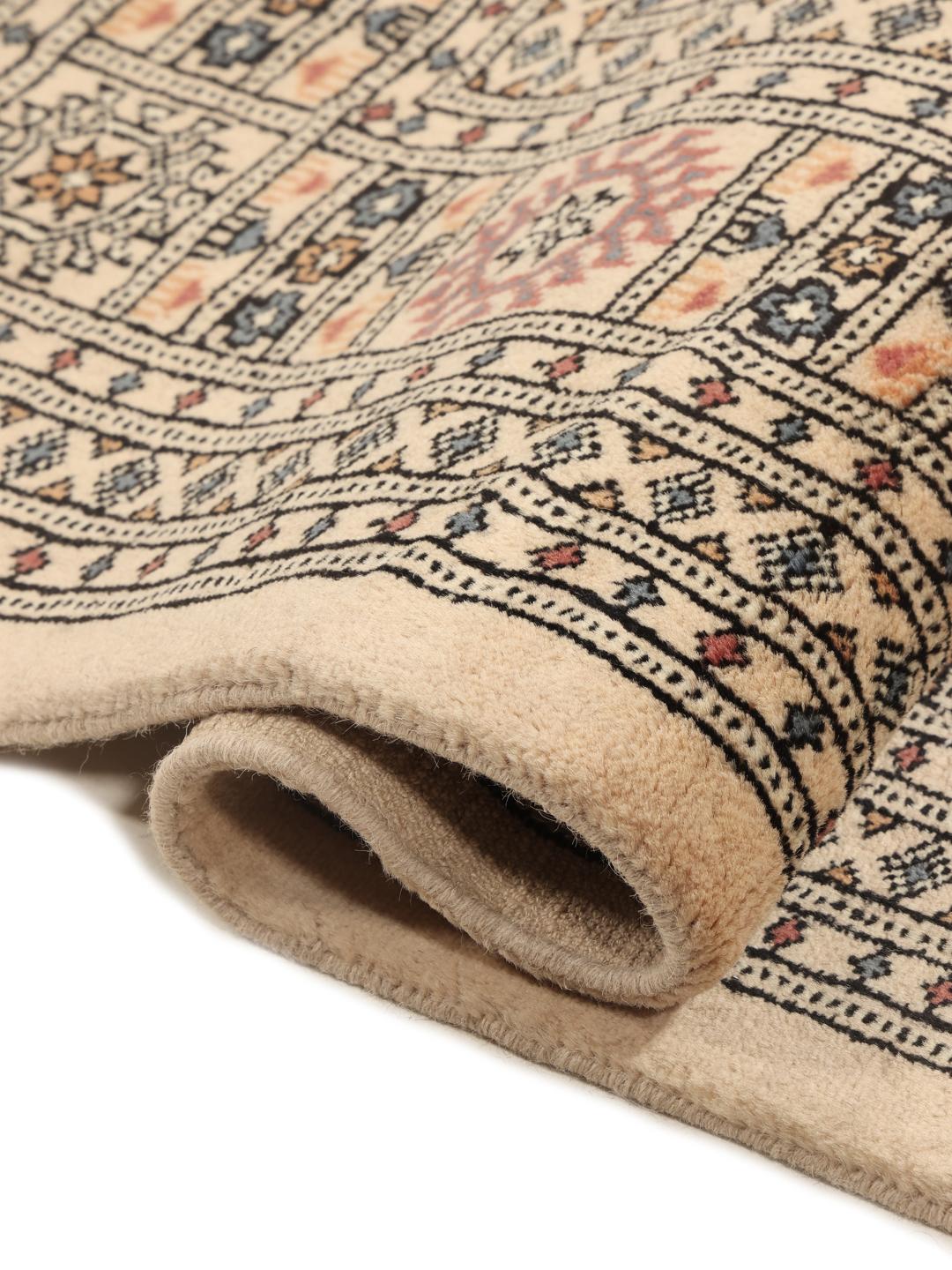 Hand-knotted Pakistan Bokhara rug with a beige wool pile
