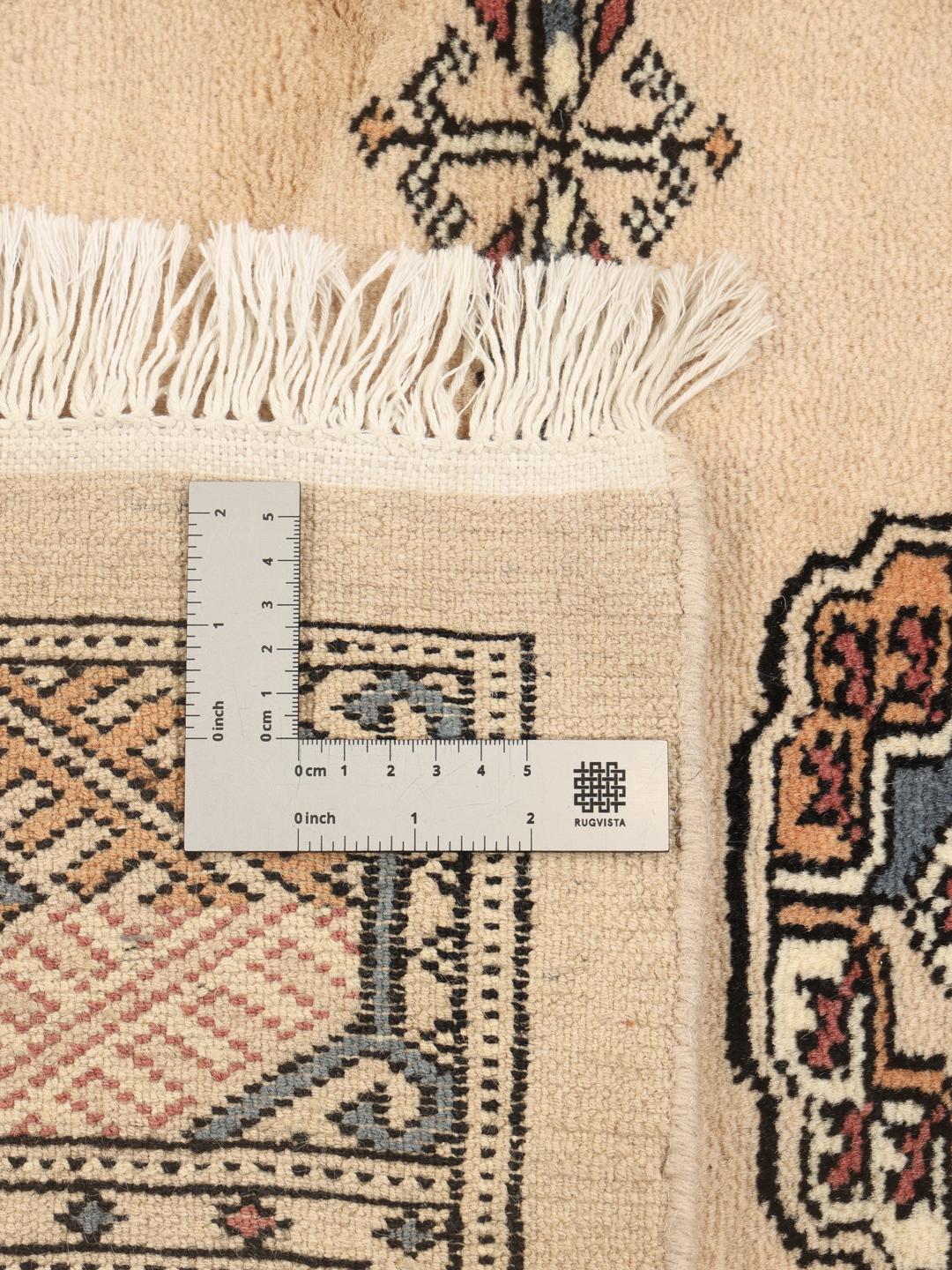Hand-knotted Pakistan Bokhara rug with a beige wool pile