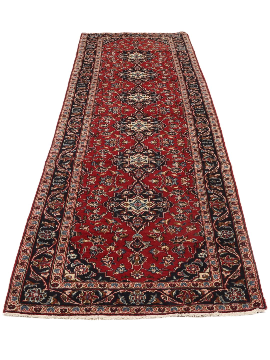Hand-knotted Keshan runner rug with a classic floral medallion design in red and blue.