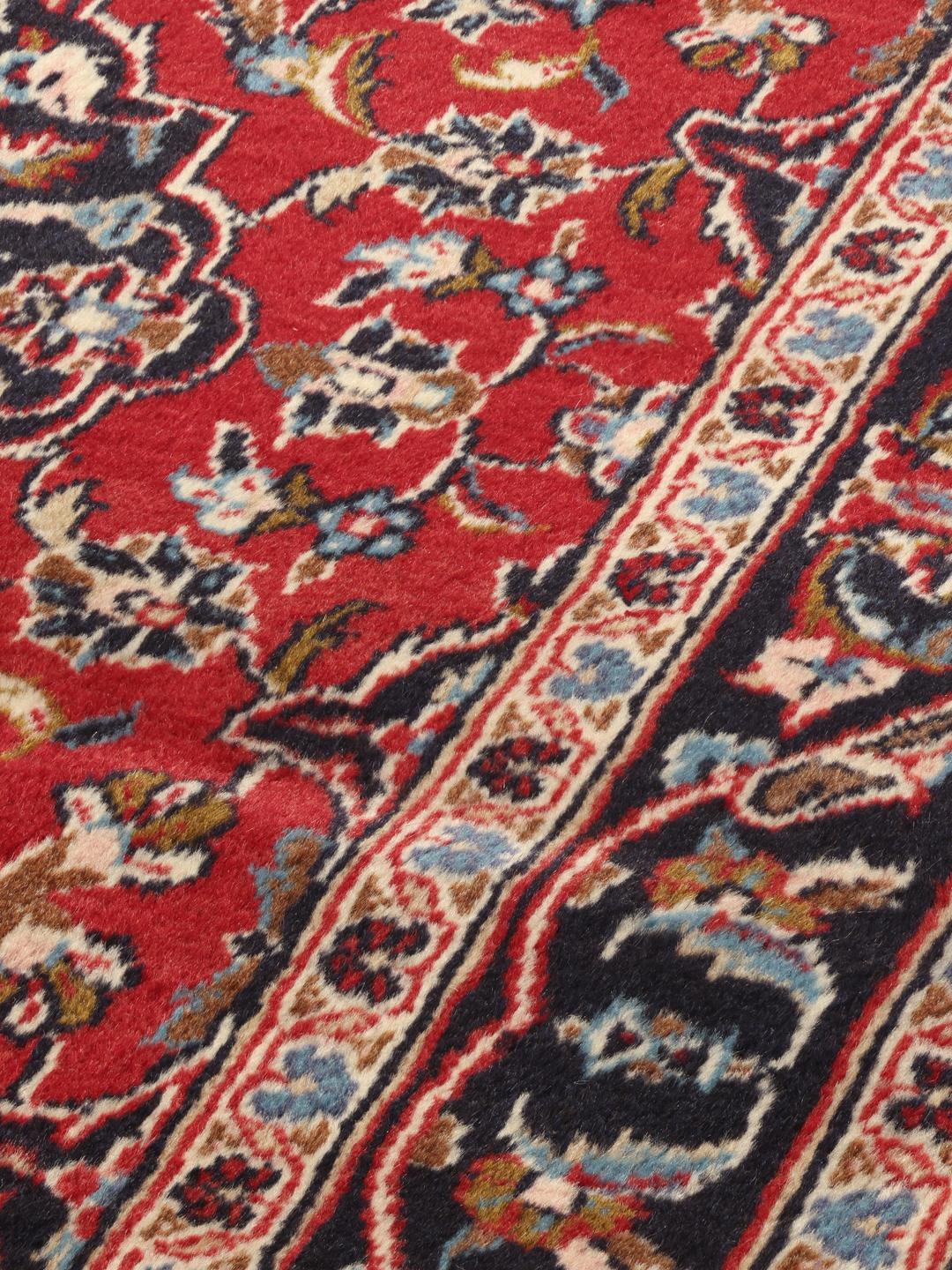 Hand-knotted Keshan runner rug with a classic floral medallion design in red and blue.