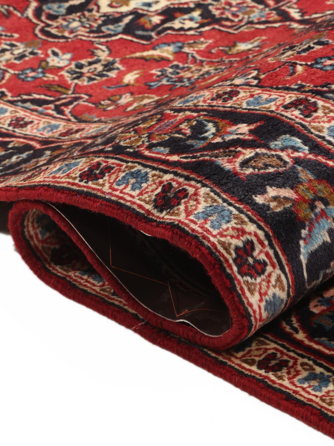 Hand-knotted Keshan runner rug with a classic floral medallion design in red and blue.