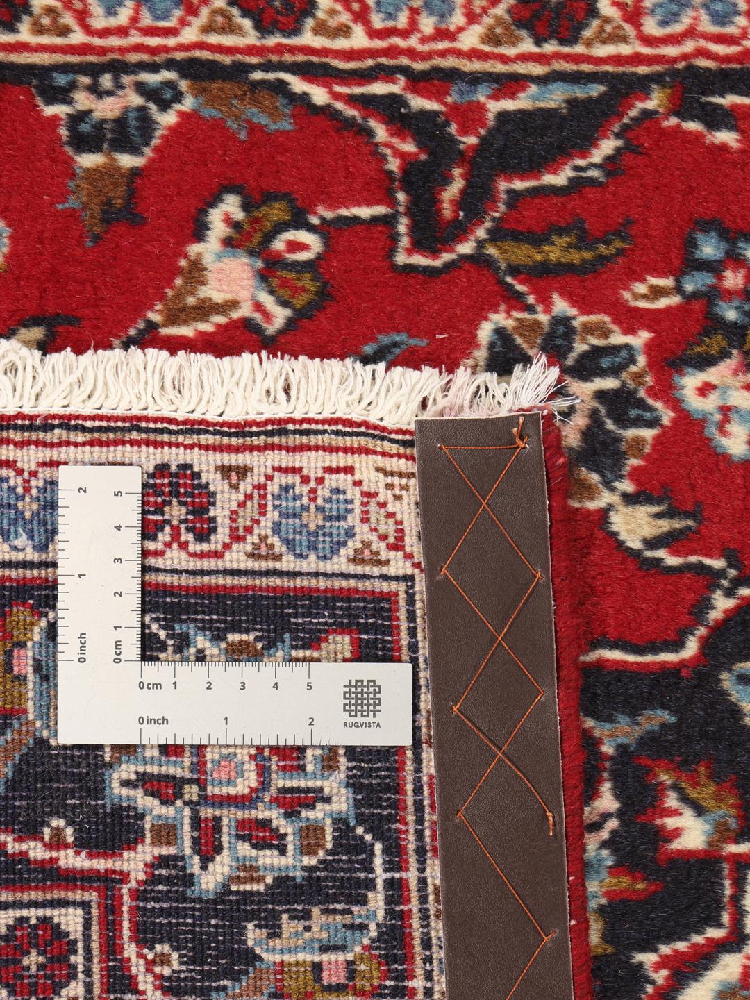 Hand-knotted Keshan runner rug with a classic floral medallion design in red and blue.