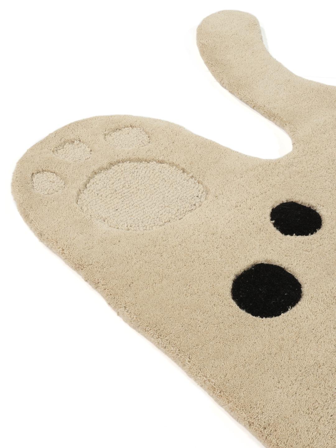 Een speels tapijt in de vorm van een kat in beige en donkergrijs met een zachte wollen pool