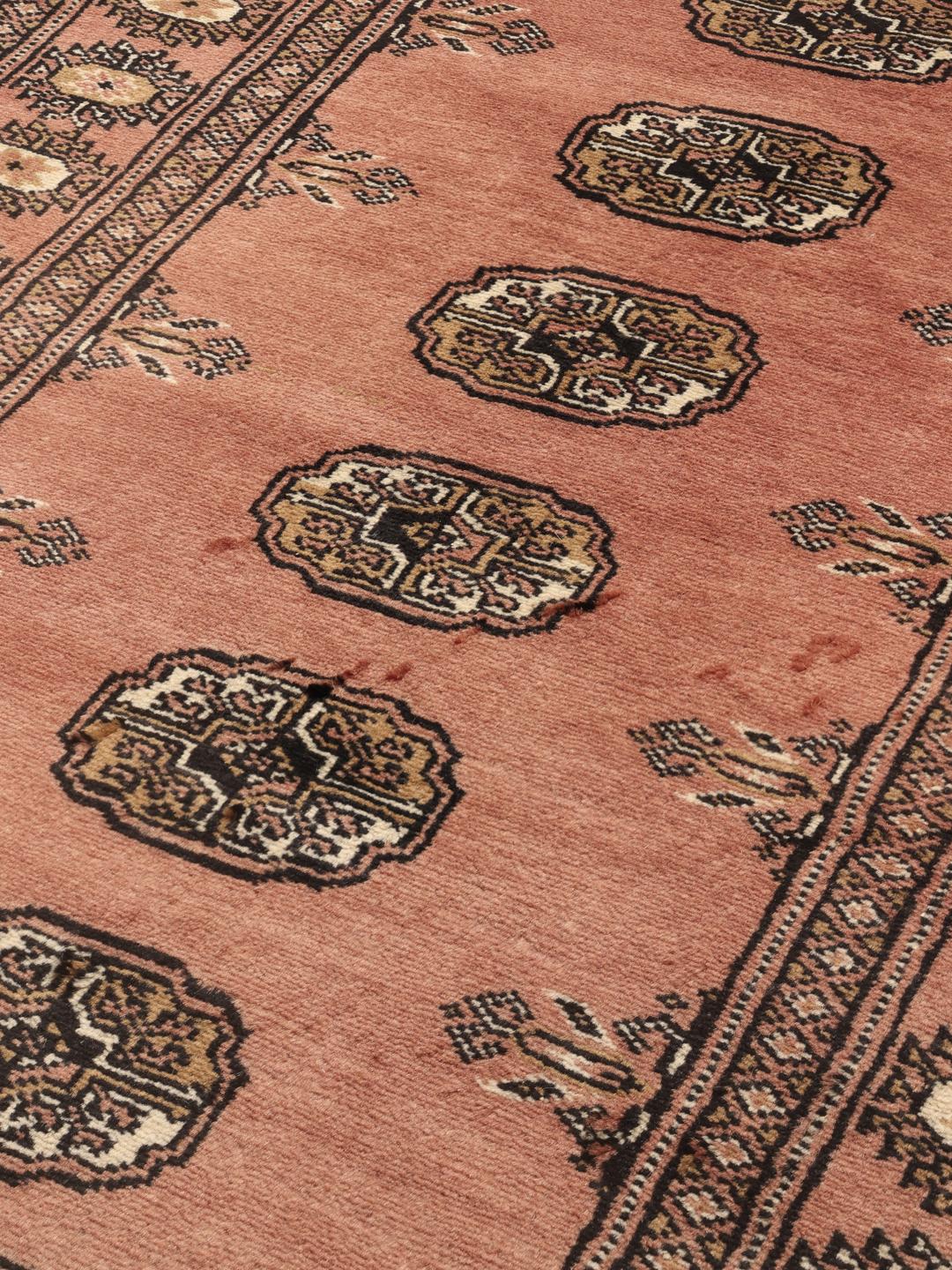 Hand-knotted Pakistan Bokhara rug in red with traditional gul patterns