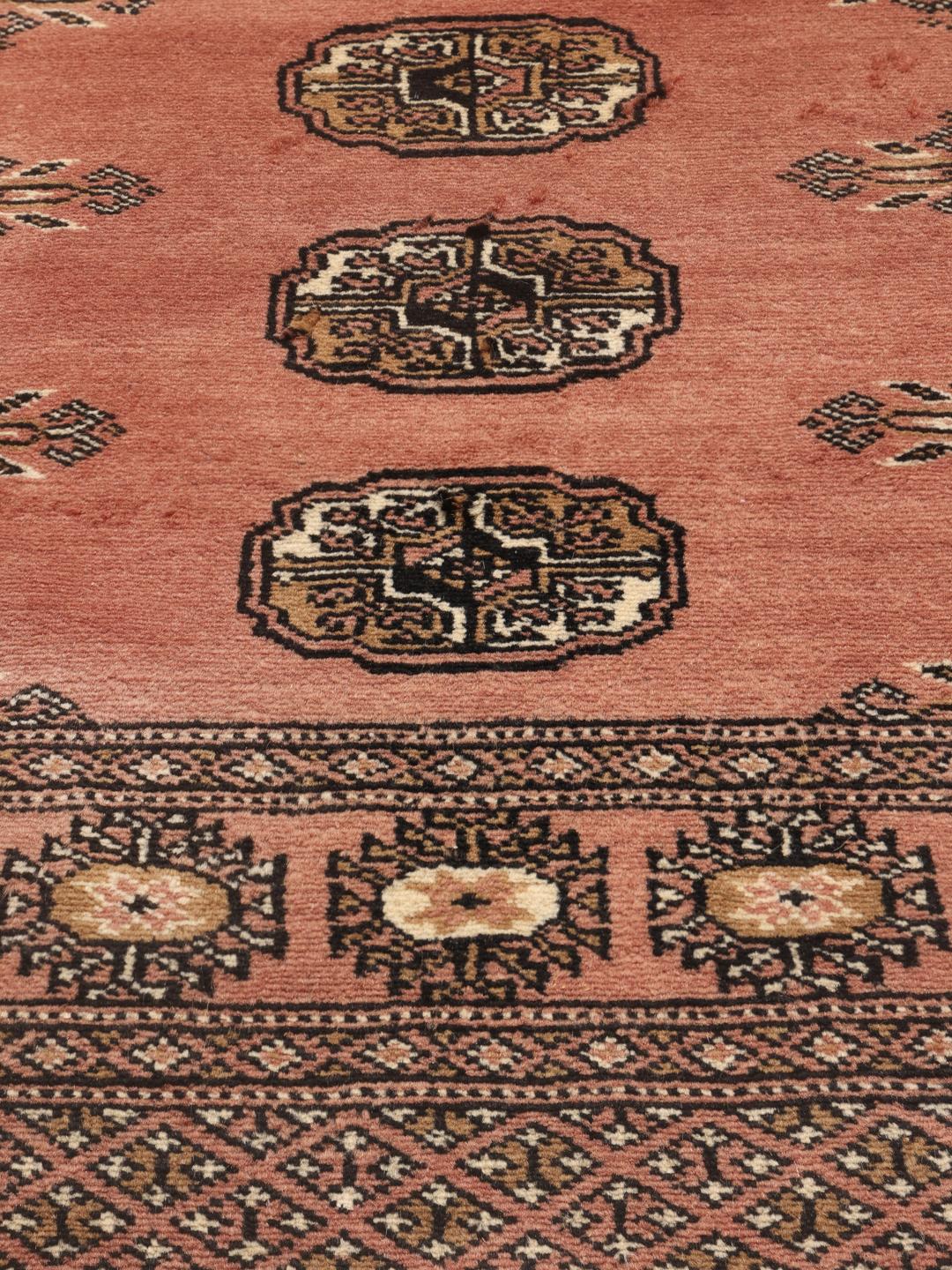 Hand-knotted Pakistan Bokhara rug in red with traditional gul patterns