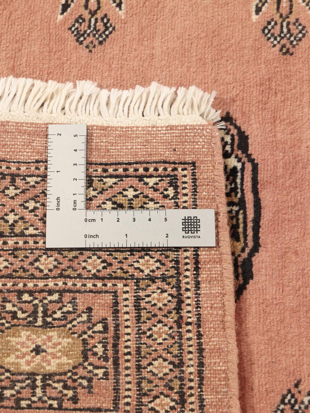 Hand-knotted Pakistan Bokhara rug in red with traditional gul patterns