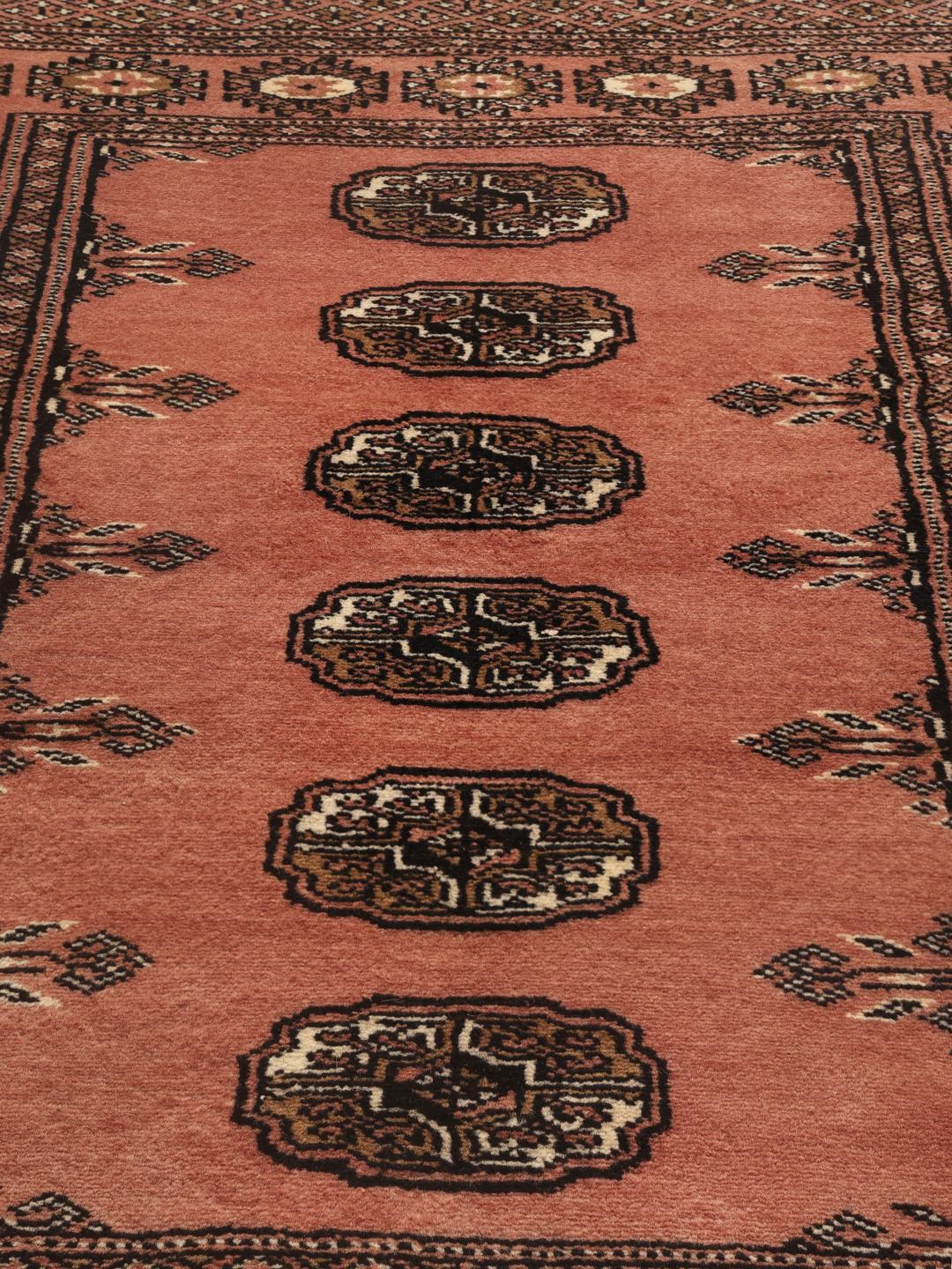 Hand-knotted Pakistan Bokhara 2ply rug in red with traditional motifs