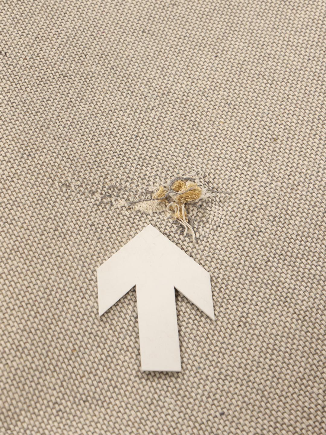 A brown rug with a diamond pattern in a warm golden tone.