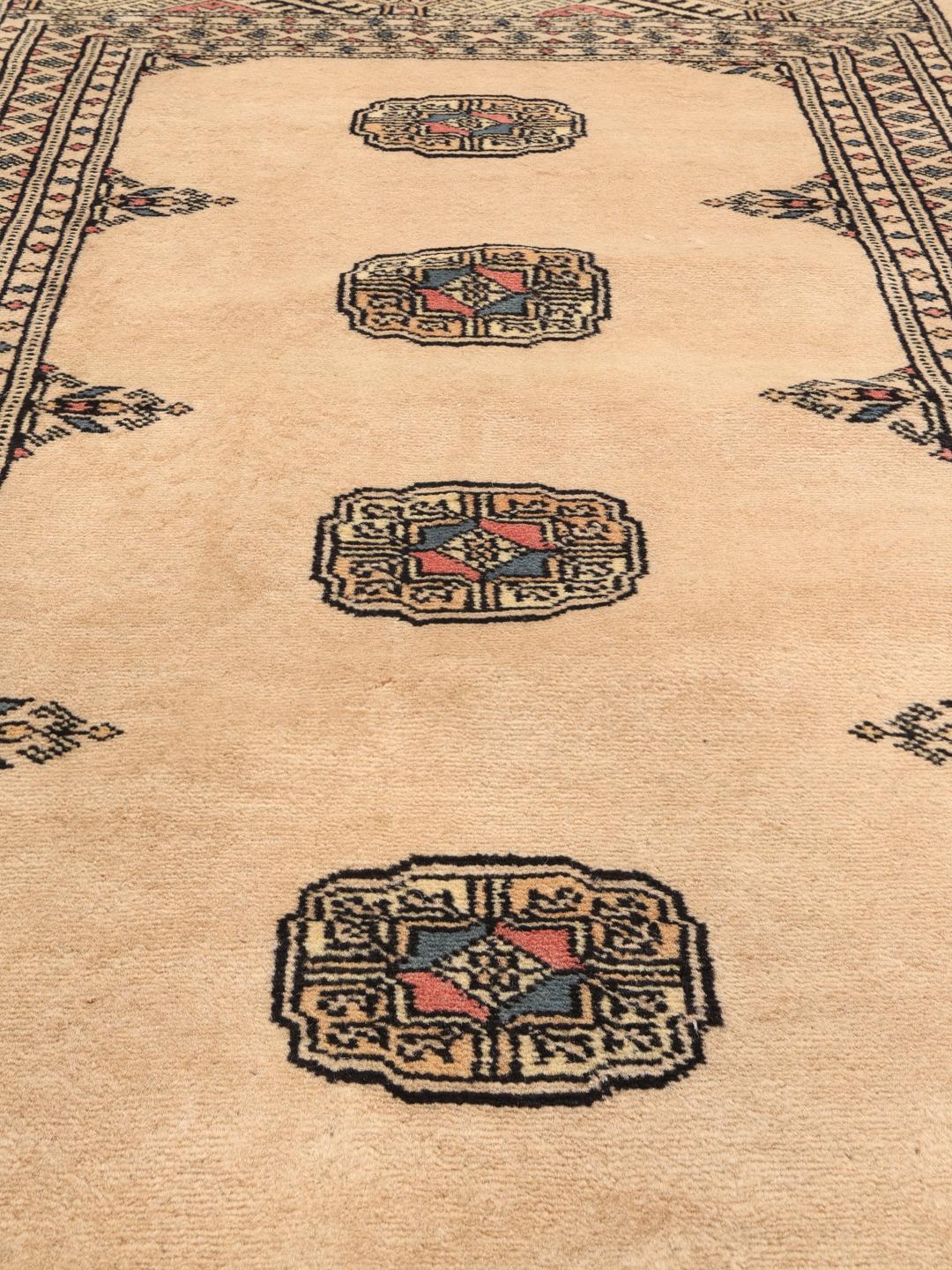 Hand-knotted Pakistan Bokhara 2ply rug in beige with traditional patterns