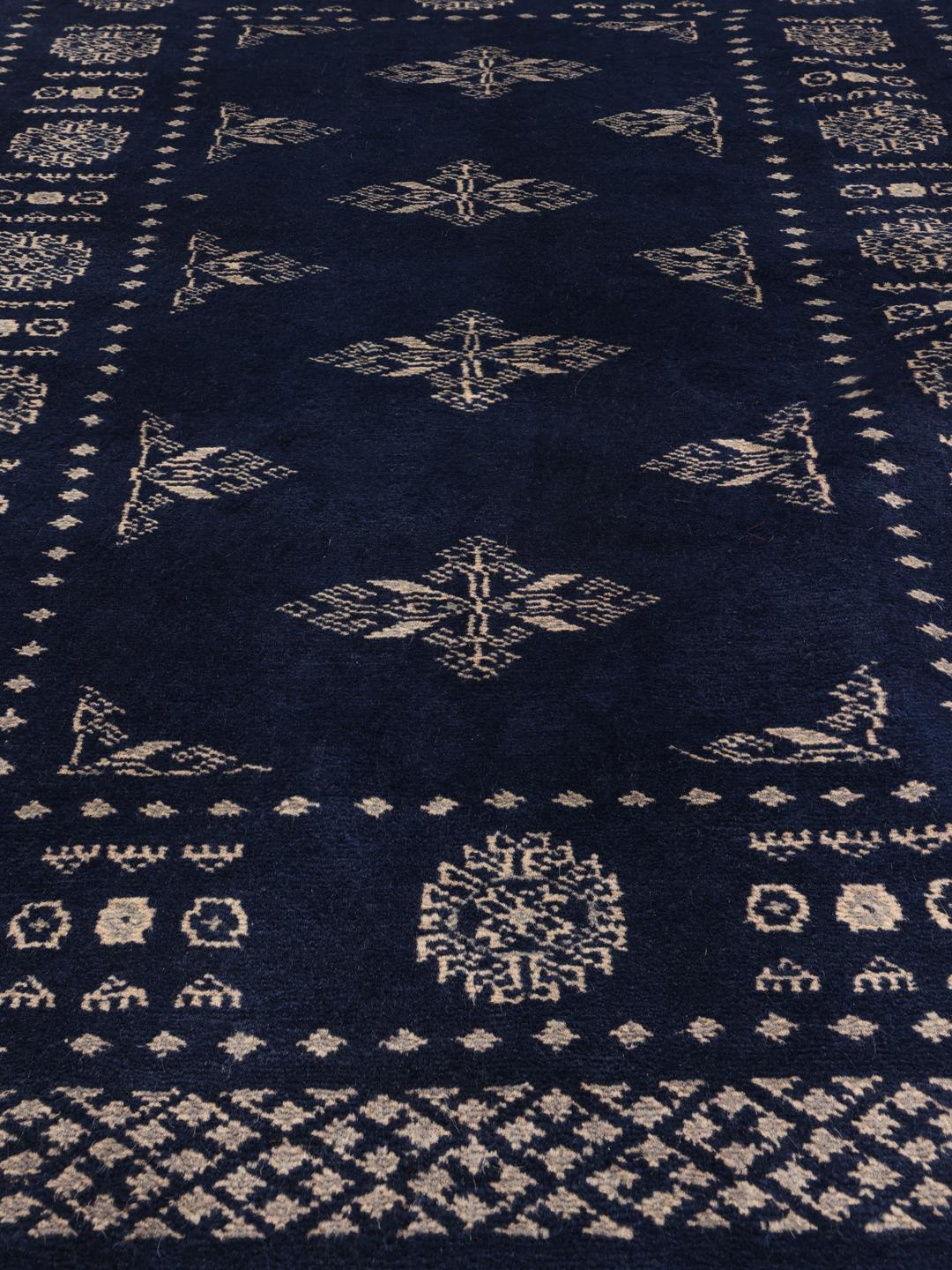 Hand-knotted Pakistan Bokhara rug with a deep blue field and intricate light-toned motifs