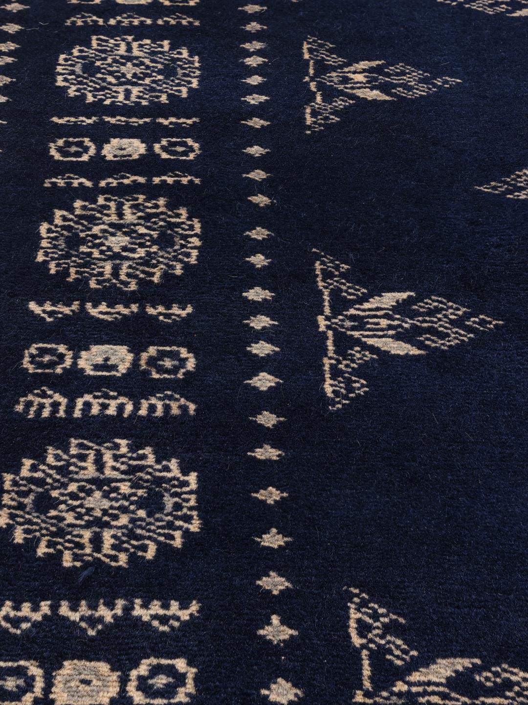Hand-knotted Pakistan Bokhara rug with a deep blue field and intricate light-toned motifs