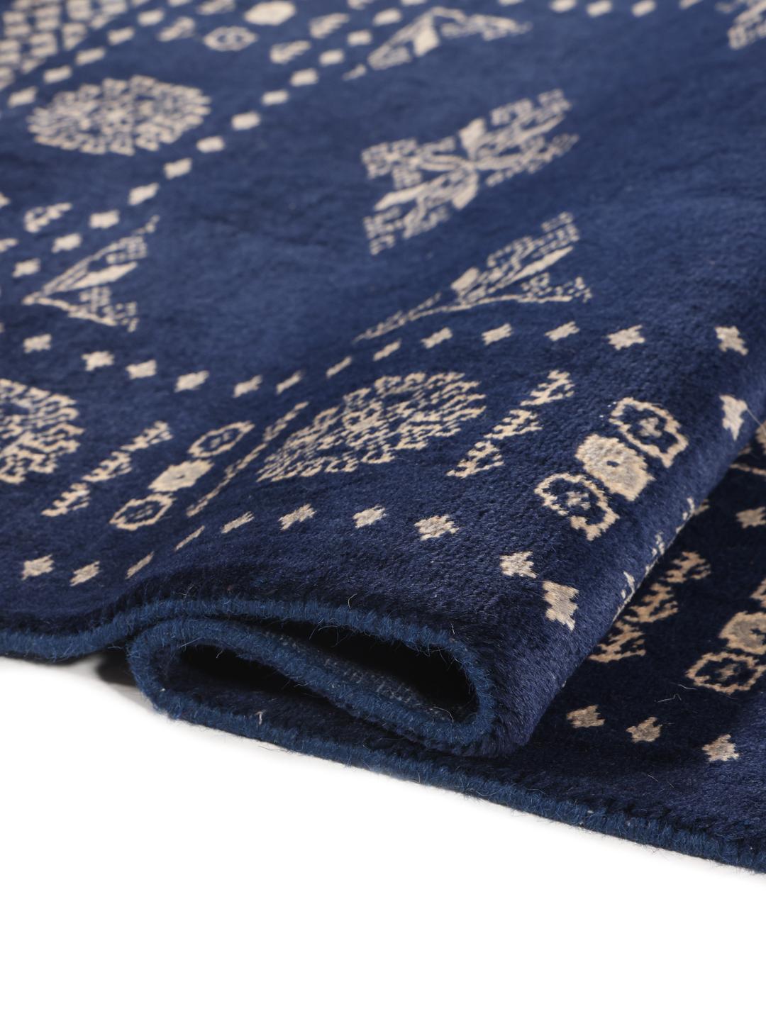 Hand-knotted Pakistan Bokhara rug with a deep blue field and intricate light-toned motifs