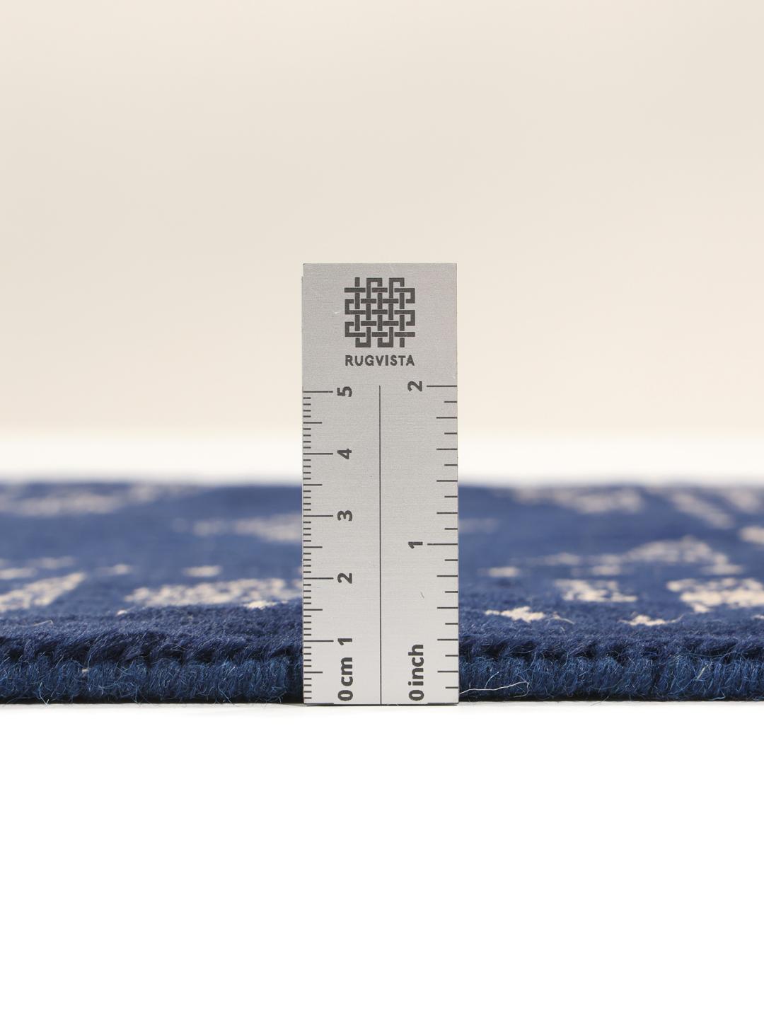 Hand-knotted Pakistan Bokhara rug with a deep blue field and intricate light-toned motifs
