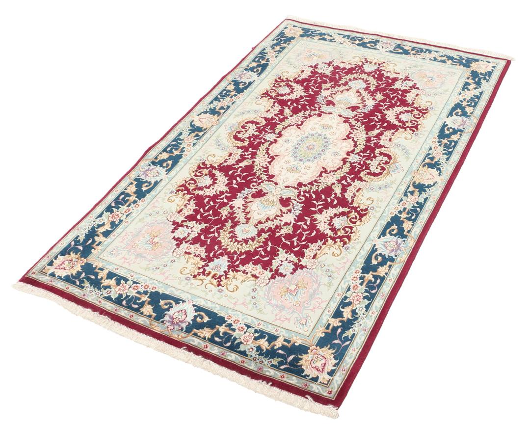 Handgeknoopt Tabriz-tapijt met bloemmotief en medaillon in rood en donkerblauw uit het Midden-Oosten