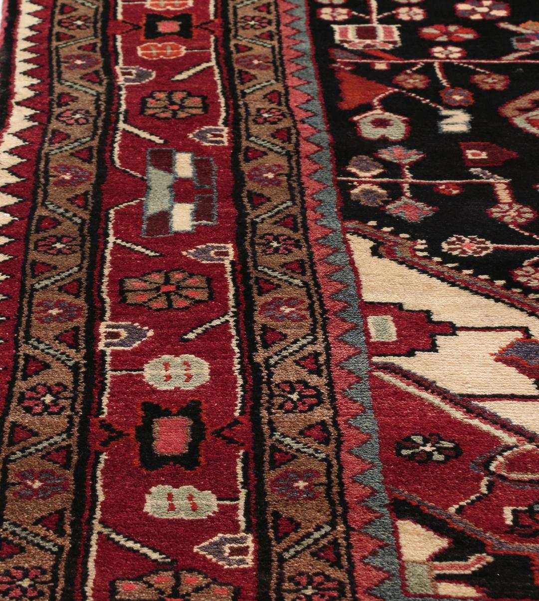 A one-of-a-kind Hamadan rug from the Middle East with a dark-red and black palette.