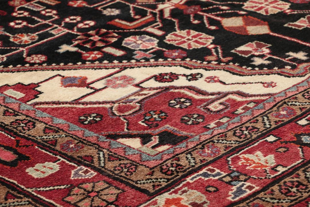 A one-of-a-kind Hamadan rug from the Middle East with a dark-red and black palette.