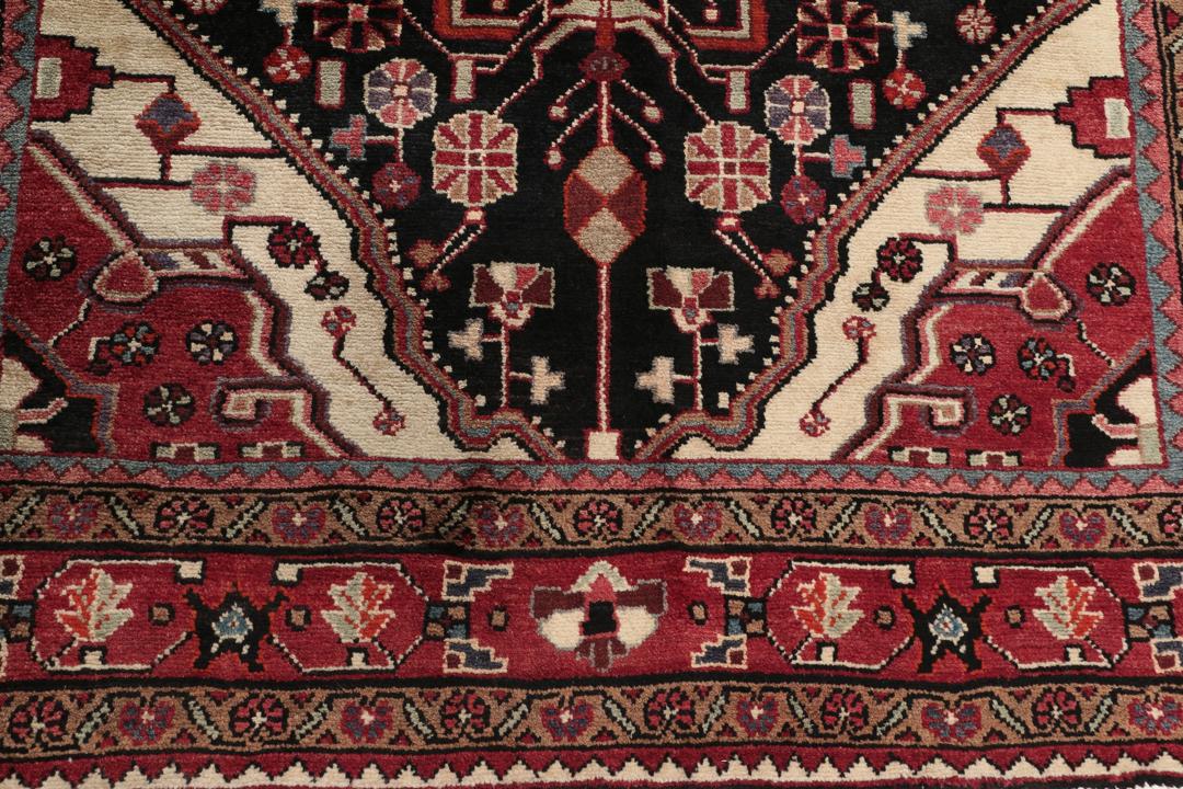 A one-of-a-kind Hamadan rug from the Middle East with a dark-red and black palette.