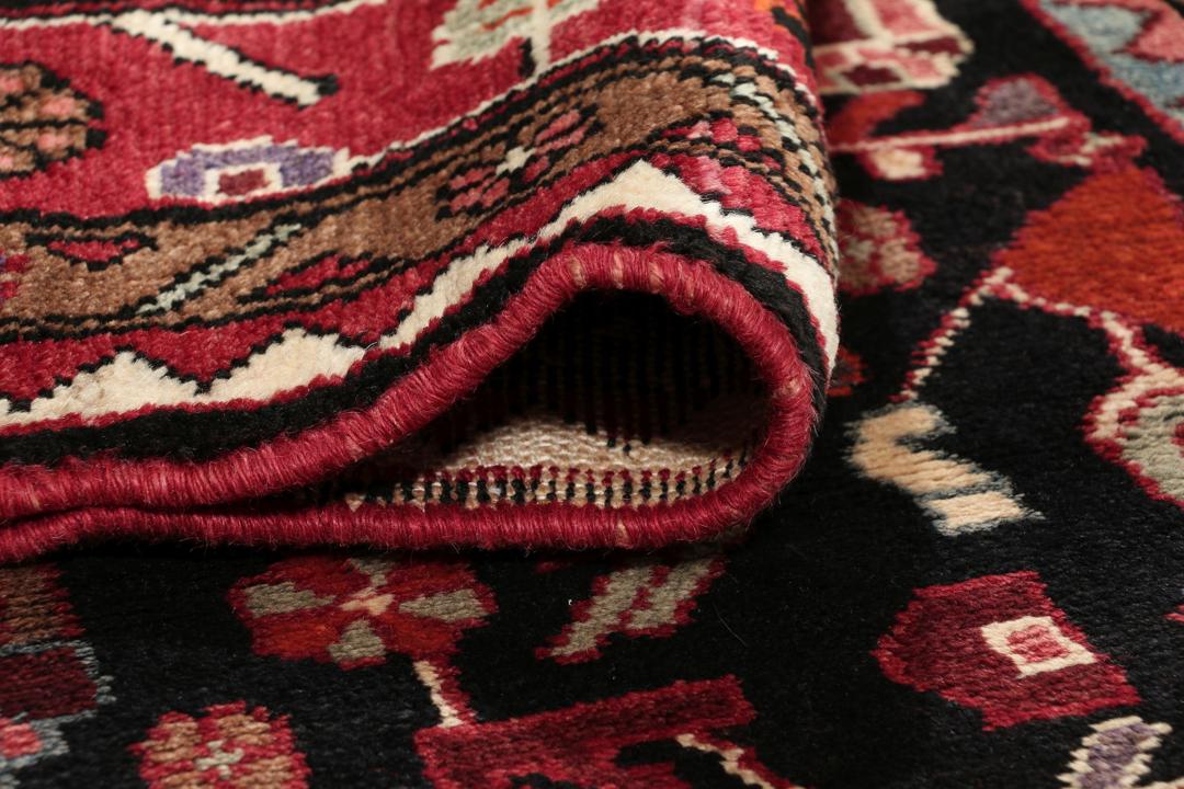 A one-of-a-kind Hamadan rug from the Middle East with a dark-red and black palette.