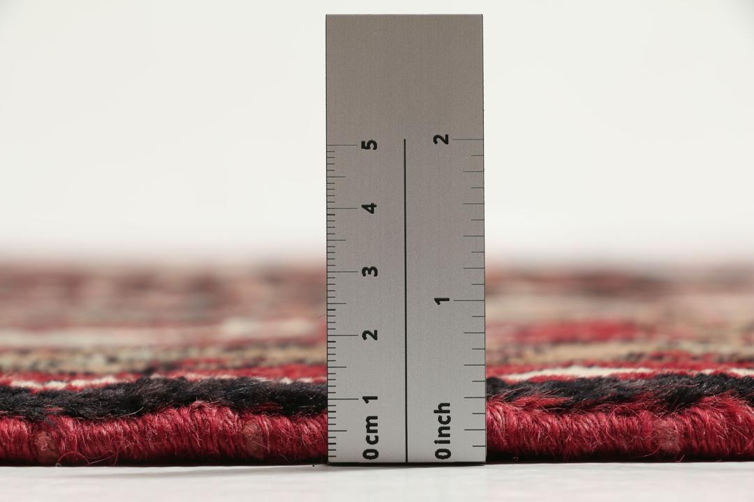 A one-of-a-kind Hamadan rug from the Middle East with a dark-red and black palette.