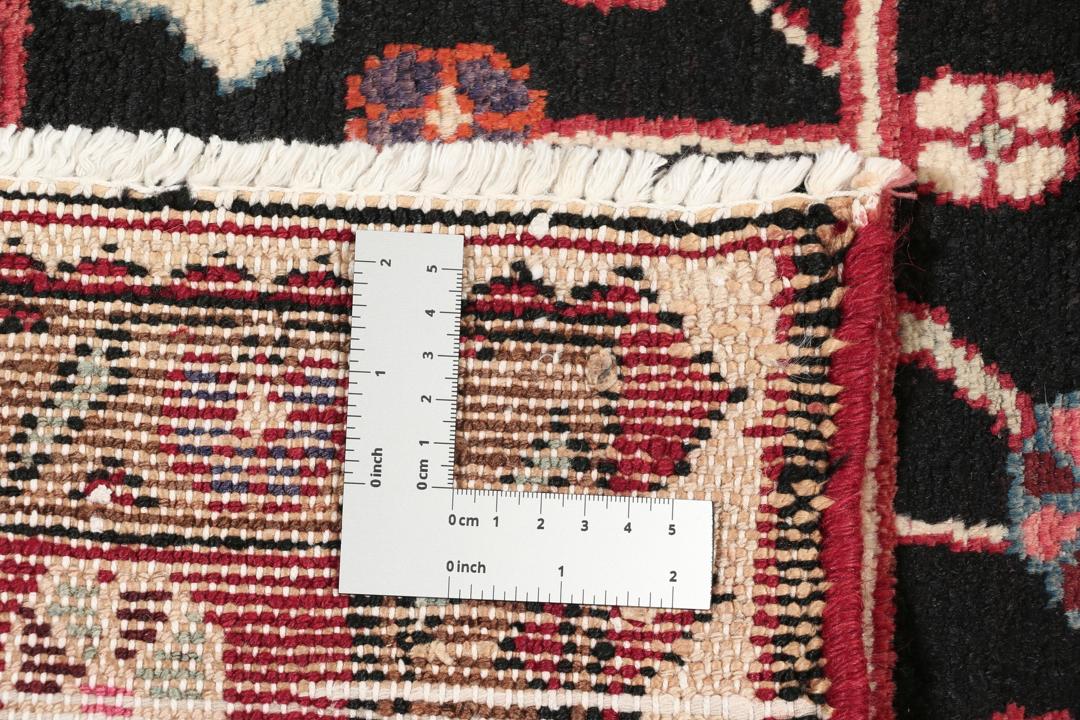 A one-of-a-kind Hamadan rug from the Middle East with a dark-red and black palette.