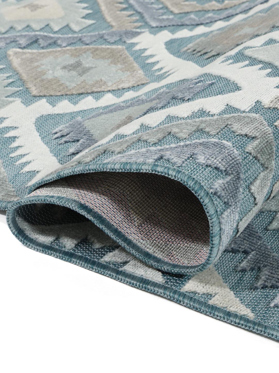 Blauw tapijt met een tactiel hoog en laag Flor patroon