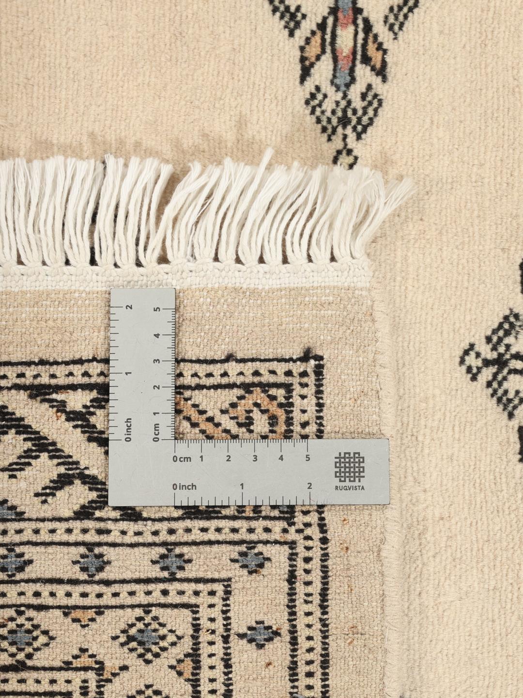 Hand-knotted beige Pakistan Bokhara rug with geometric motifs
