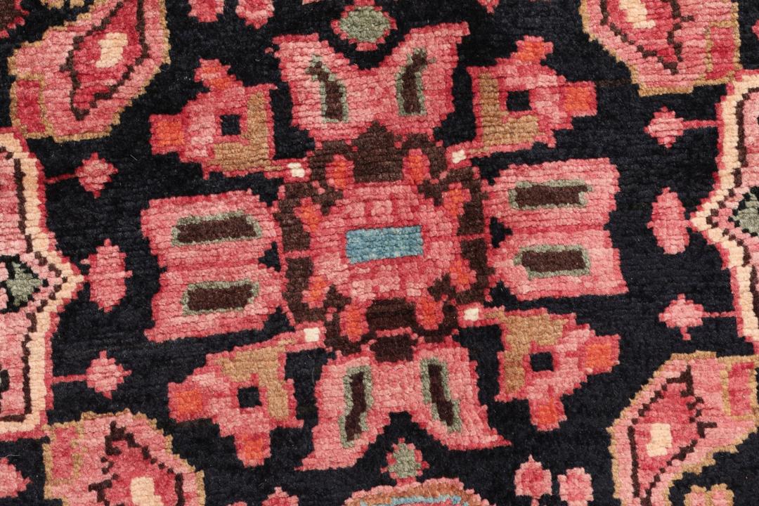 A rectangular hand-knotted Hamadan rug from the Middle East with a dark-red and black colour palette.