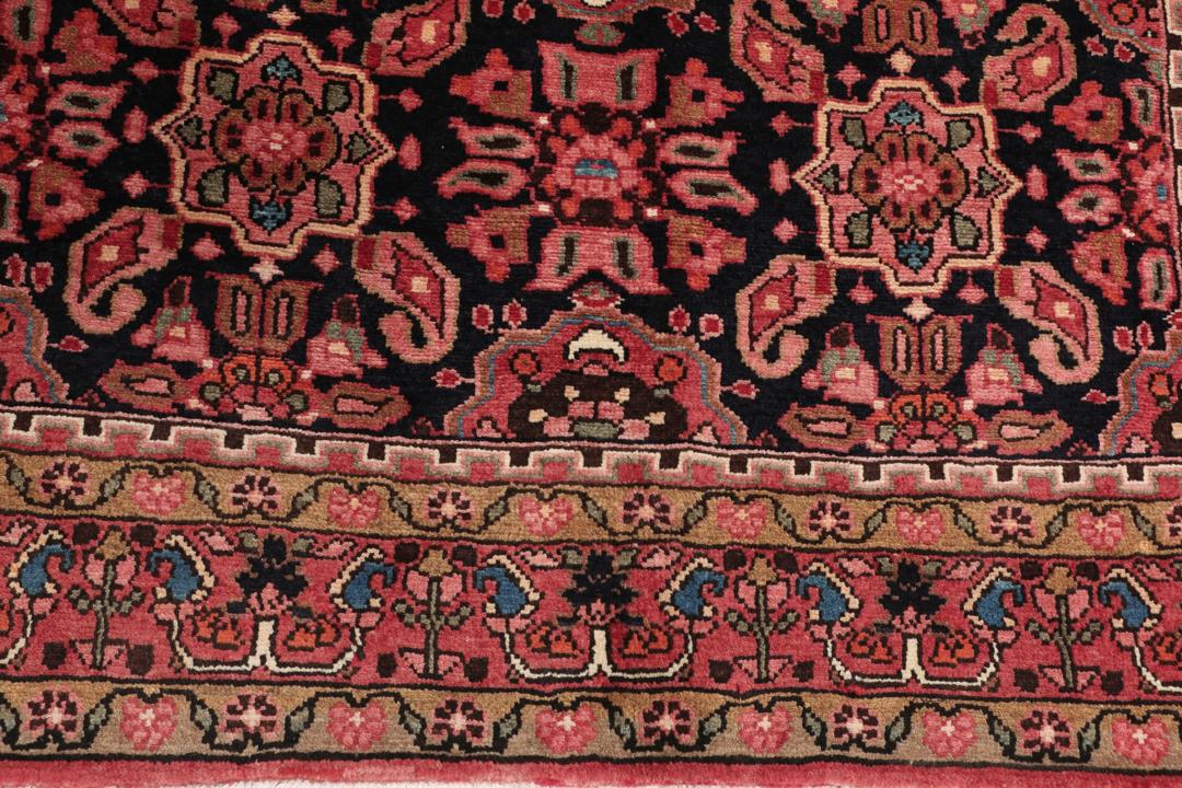 A rectangular hand-knotted Hamadan rug from the Middle East with a dark-red and black colour palette.