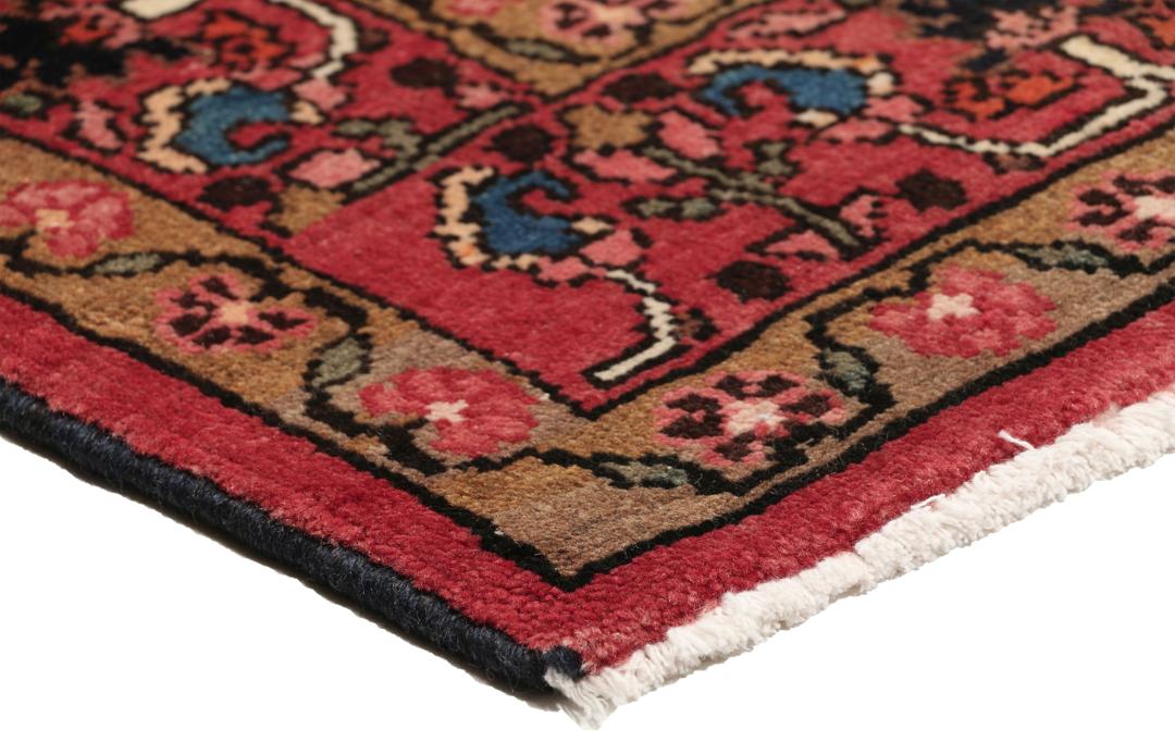 A rectangular hand-knotted Hamadan rug from the Middle East with a dark-red and black colour palette.