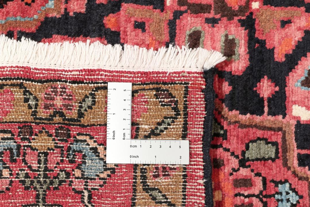 A rectangular hand-knotted Hamadan rug from the Middle East with a dark-red and black colour palette.
