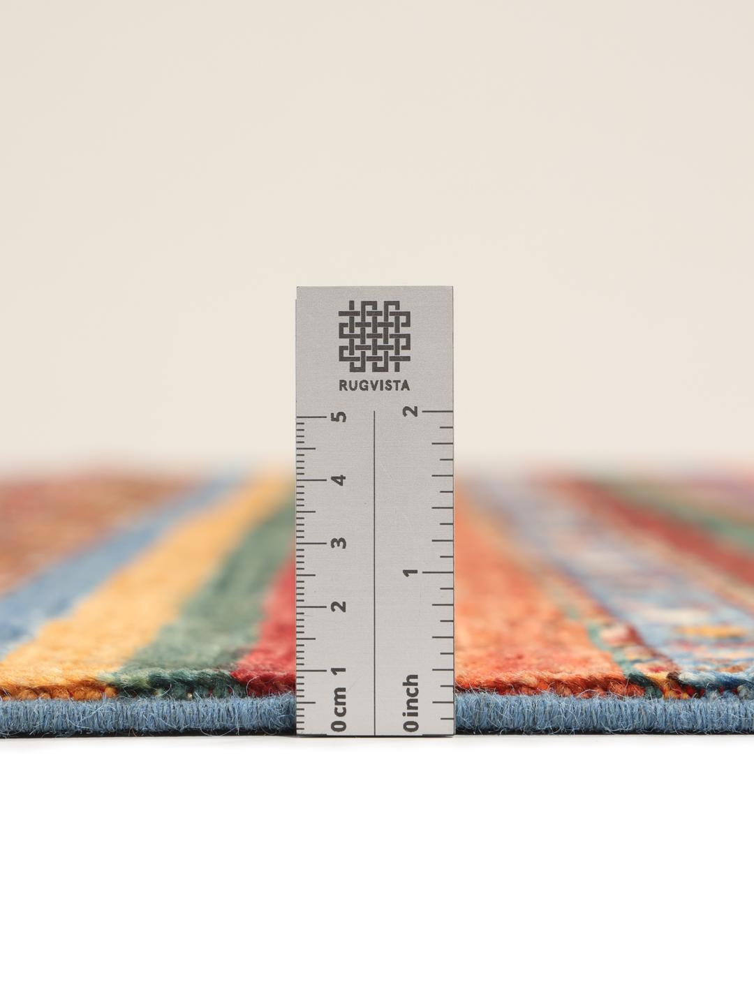 Handgeknoopt Afghaans tapijt met ingewikkelde geometrische patronen in rood, blauw en bruin.