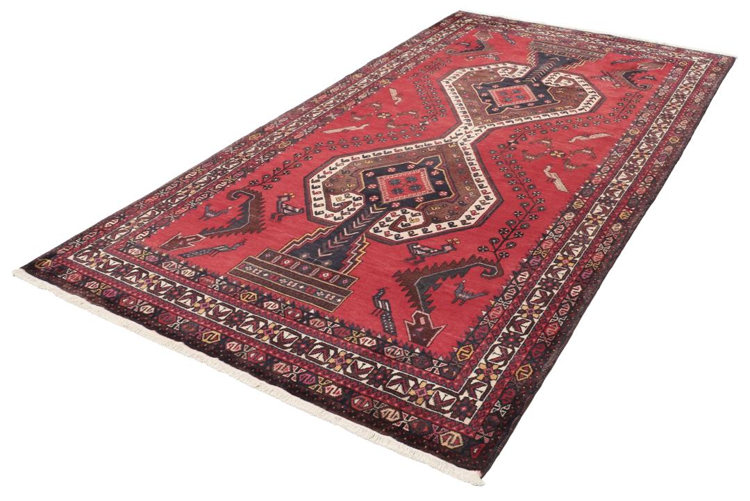 Et håndknyttet Afshar-tæppe fra Mellemøsten med et modigt rødt felt og geometriske motiver.