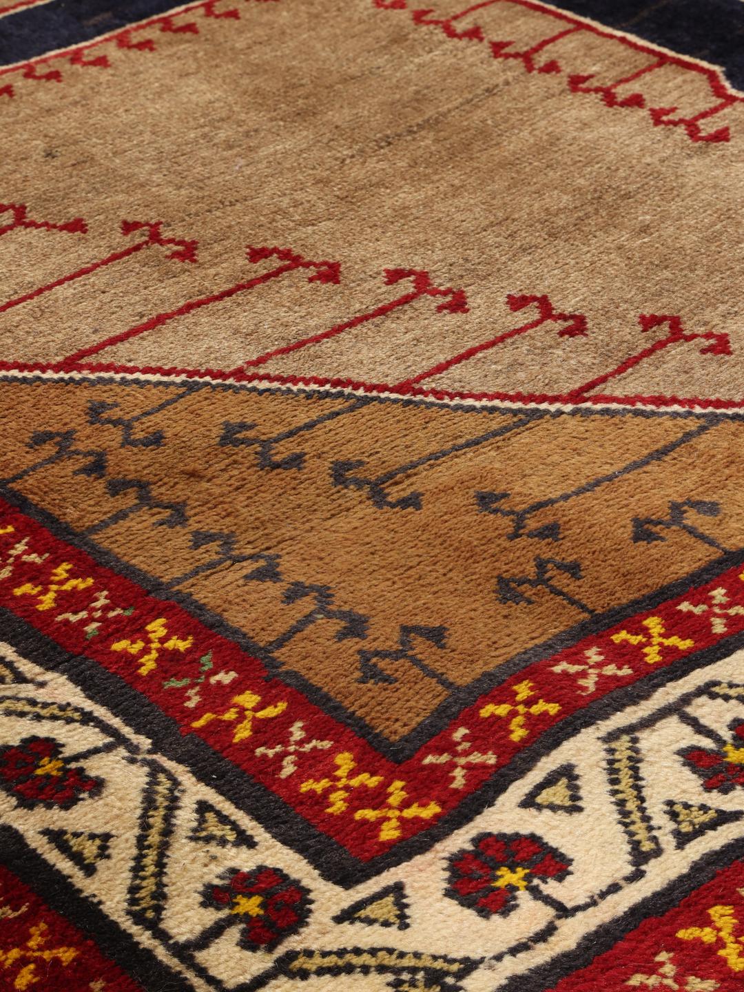 Hand-knotted Ghashghai rug from the Middle East with a brown field and geometric patterns
