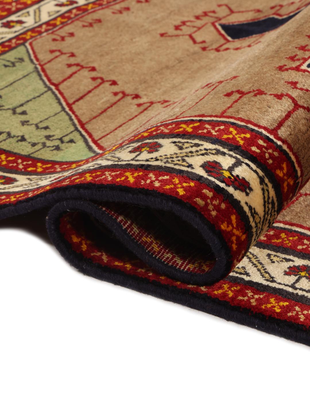 Hand-knotted Ghashghai rug from the Middle East with a brown field and geometric patterns