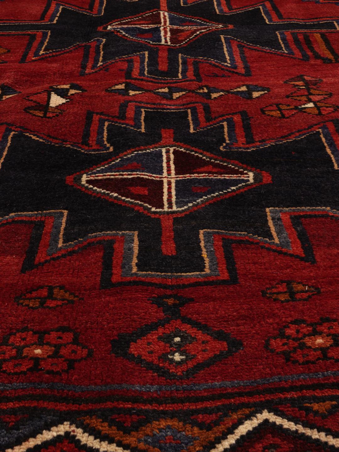 Hand-knotted Lori rug with red and black geometric tribal patterns from the Middle East