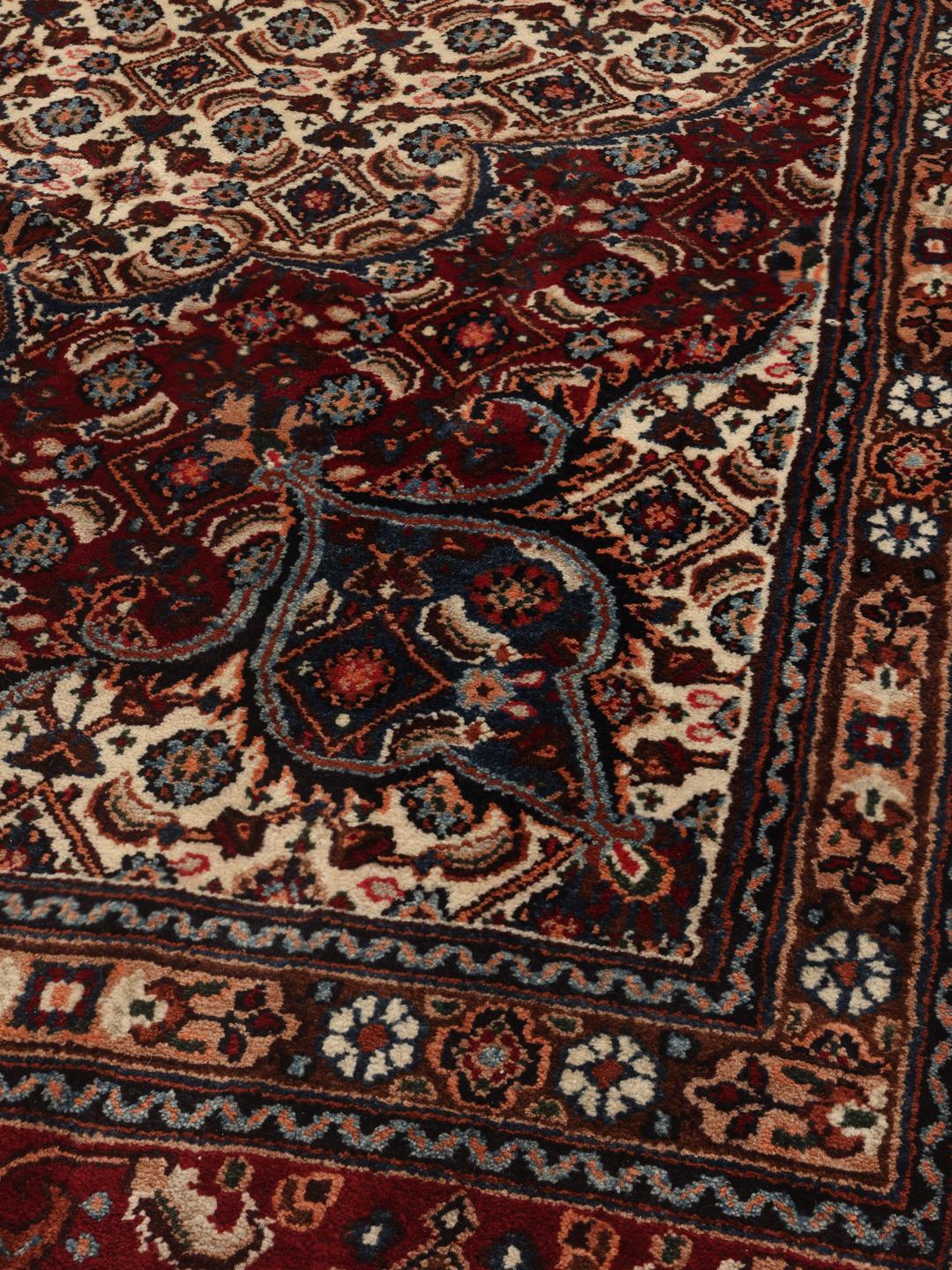 A one-of-a-kind hand-knotted Moud rug in dark-red and beige with an ornate floral medallion pattern.