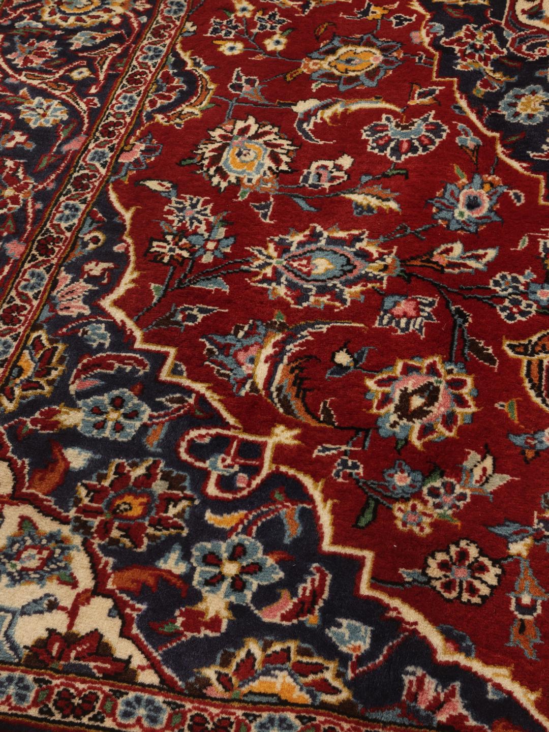 Hand-knotted Keshan rug from the Middle East in shades of red and blue.
