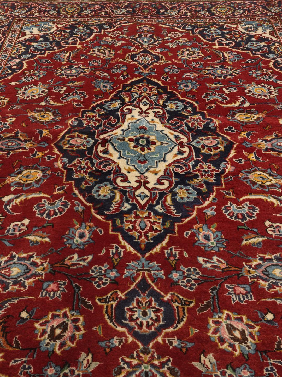 Hand-knotted Keshan rug from the Middle East in shades of red and blue.