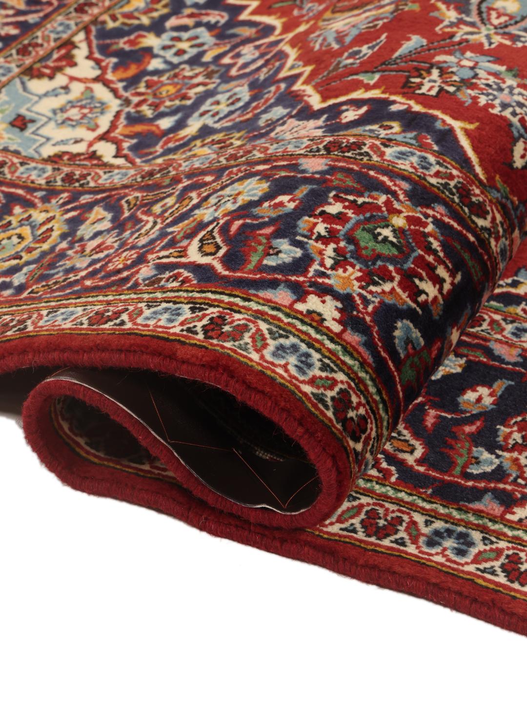 Hand-knotted Keshan rug from the Middle East in shades of red and blue.