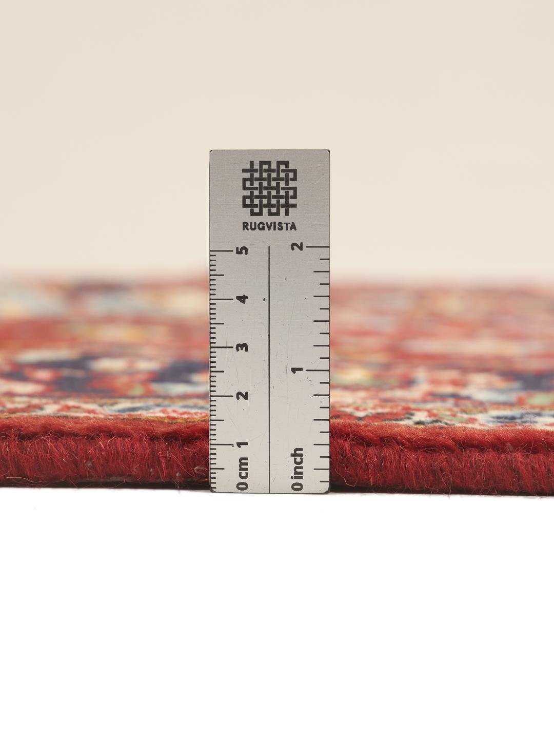 Hand-knotted Keshan rug from the Middle East in shades of red and blue.